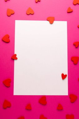 Dikey beyaz dikdörtgen fotokopi alanı ve pembe arka planda kırmızı kalp şekilleri. Sevgililer günü, aşk, aşk ve kutlama konsepti.