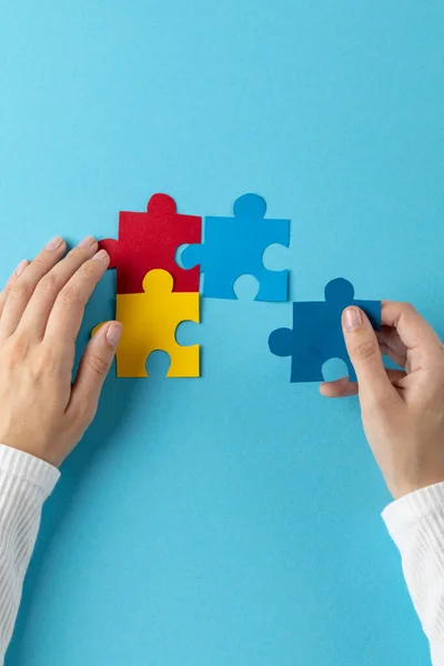 Vertical Hands Putting Jigsaw Puzzle Pieces Together Blue Background Copy — Stock Photo, Image