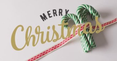 Noel tebriklerinin animasyonu Noel şeker kamışları üzerine yazılmış bir mesajdır. Noel, şenlik, kutlama ve gelenek konsepti dijital olarak oluşturuldu.
