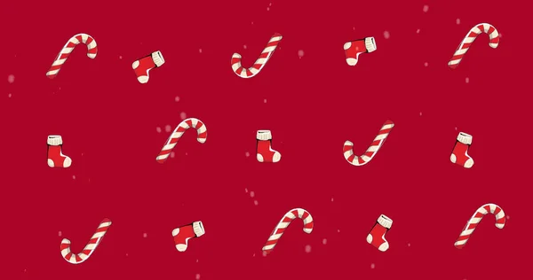 Image of multiple sock and candy cane on red background. christmas, winter, tradition and celebration concept digitally generated image.