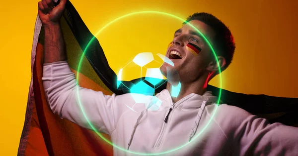 Digital composite of caucasian soccer player with flag celebrating success with abstract neon design. Computer graphic, digital composite, soccer, design, athlete, sport, victory, german flag.