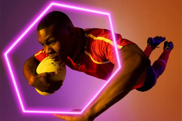 Hexagon Neon African American Young Rugby Player Jumping Colored Background — Stock Photo, Image