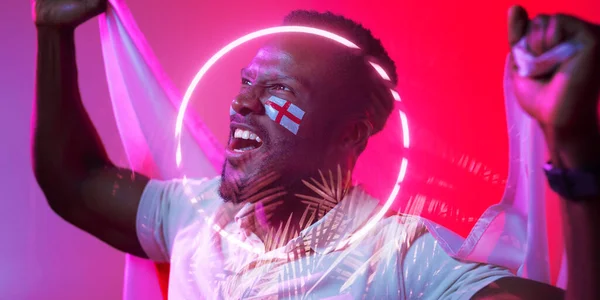 African american male fan with england flag and face paint screaming by circle and plants. Composite, sport, competition, soccer, support, nature, shape, illuminated, patriotism, cheering, match.