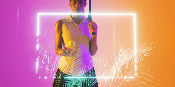 Midsection of african american tennis player with ball and racket by illuminated rectangle and plant. Copy space, composite, sport, competition, shape, nature, match and abstract concept.