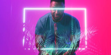 Afrika kökenli Amerikalı erkek tenisçi raket tutarken bitkileri ve dikdörtgeni aydınlattı. Boşluğu kopyala, kendine güven, kompozit, spor, rekabet, şekil, doğa oyunu, eşleşme ve soyut.