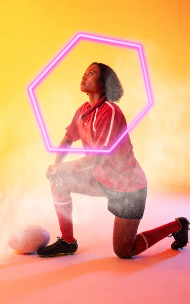 Composite Biracial Female Rugby Player Kneeling Illuminated Hexagon Colored Background — Stock Photo, Image