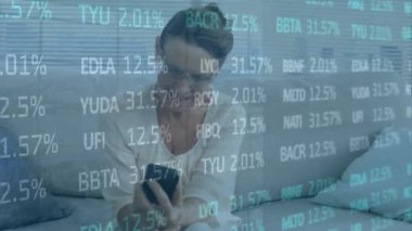 Animation of financial data processing over caucasian woman using smartphone. Global business, finance, computing and data processing concept digitally generated video.