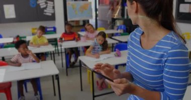 Animation of data processing and globe over diverse schoolchildren in class. Global education, computing and data processing concept digitally generated video.