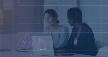 Animation of graphs and numbers over diverse female coworkers analyzing report over laptop in office. Digital composite, multiple exposure, business, report, discussion, teamwork and technology.