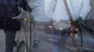 Animation of cars over diverse people walking with bikes. Global travel, transport and lifestyle concept digitally generated video.