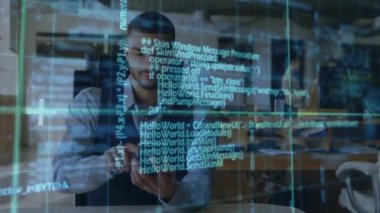 Animation of data processing over biracial businessman using digital tablet at office. Computer interface and business technology concept