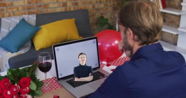 Animation of caucasian man using laptop with copy space and caucasian woman. Celebration and party concept digitally generated video.