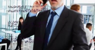 Animation of squares over caucasian businessman talking on smartphone. Global business, finances and digital interface concept digitally generated video.
