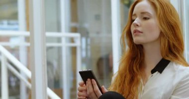 Animation of 6g text over caucasian businesswoman using smartphone. Global business, finances and digital interface concept digitally generated video.