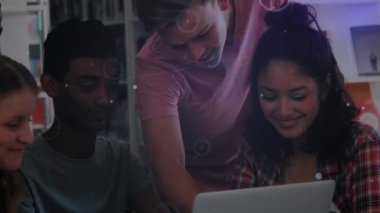 Animation of connected dots, lens flare over diverse students using laptop in library. Digital composite, multiple exposure, communication, illuminated, education, technology concept.
