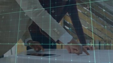 A group of executives are discussing a blueprint in the office. Global sports business digital interface technology and networking concept digitally generated video.