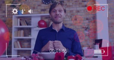 Animation of icons and camera recording screen over caucasian man having online call. Global social media, technology and digital interface concept digitally generated video.