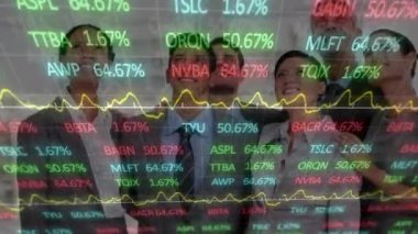 Animation of trading board, graph on diverse happy coworkers looking up on screen in office. Digital composite, multiple exposure, stock market, report, business, abstract and technology concept.