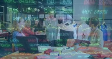 Animation of financial data processing over diverse businesswomen in office. Global business, finance, computing and data processing concept digitally generated video.