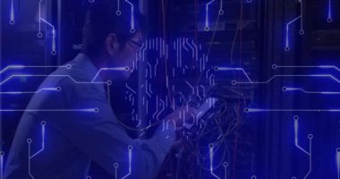 Animation of computer circuit board and digital brain over asian man in server room. Global technology, online security and digital interface concept digitally generated video.