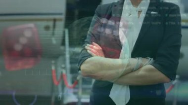 Animation of globe, binary codes, trading board, rolling dice, biracial woman standing arms crossed. Digital composite, multiple exposure, stock market, coding, globalization and business concept.