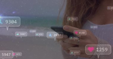 Animation of social media icons with numbers over caucasian woman using smartphone. Global social media, technology and digital interface concept digitally generated video.