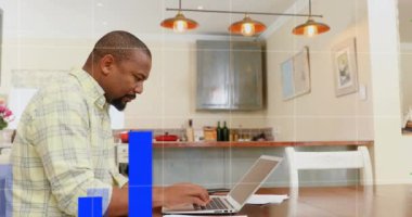 Animation of financial data processing over african american man using laptop. Global lifestyle, finances and digital interface concept digitally generated video.