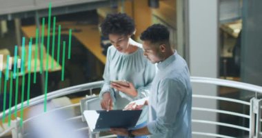 Animation of financial data processing over diverse business people discussing work at office. Global business, finances and digital interface concept digitally generated video.