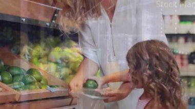 Animation of financial dat processing over caucasian mother with daughter shopping. Global shopping, business, finance, computing and data processing concept digitally generated video.