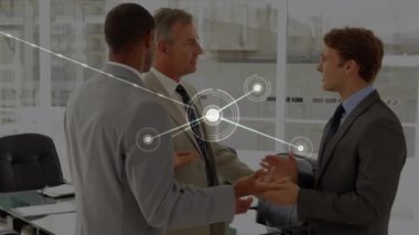 Animation of network of connections with icons over diverse business people in office. Global connections, business, finance, computing and data processing concept digitally generated video.