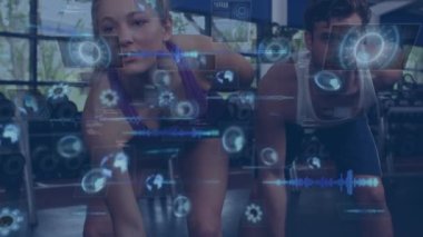 Animation of data processing over people lifting weights, exercising in gym. Global sports, fitness, computing and data processing concept digitally generated video.