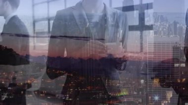 Animation of caucasian coworkers talking holding tea cup on illuminated cityscape in background. Digital composite, multiple exposure, drink, discussion, communication and technology concept.