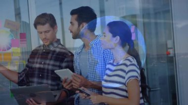 Animation of globe and cityscape over diverse business people in office. Global business and digital interface concept digitally generated video.