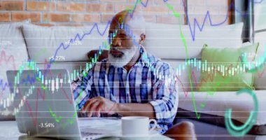Animation of financial data processing over african american man using laptop. Global lifestyle, finances and digital interface concept digitally generated video.
