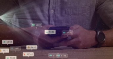 Animation of social media icons with numbers over caucasian man using smartphone. Global social media, technology and digital interface concept digitally generated video.