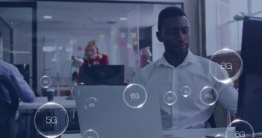 Animation of 6g texts over african american man using laptop. Global business and digital interface concept digitally generated video.