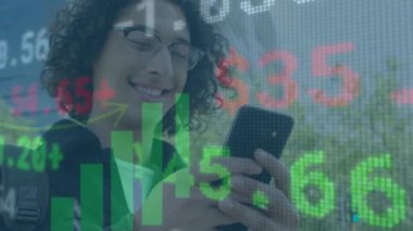 Animation of financial data processing over caucasian man using smartphone. Global business, finance, computing and data processing concept digitally generated video.