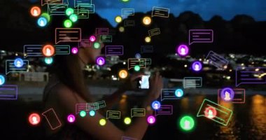 Animation of social media icons and data processing over biracial woman using smartphone. Global social media, business, finance, computing and data processing concept digitally generated video.