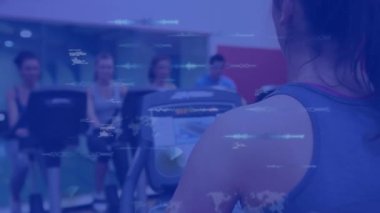 Animation of data processing over people on stationary bikes, exercising in gym. Global sports, fitness, computing and data processing concept digitally generated video.