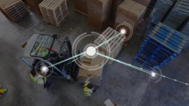 Animation of connected dots over high angle view of diverse coworkers examining boxes on forklift. Digital composite, multiple exposure, communication, warehouse, teamwork and distribution concept.
