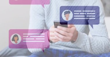 Animation of social media icons with speech bubbles over caucasian man using smartphone. Global social media, technology and digital interface concept digitally generated video.