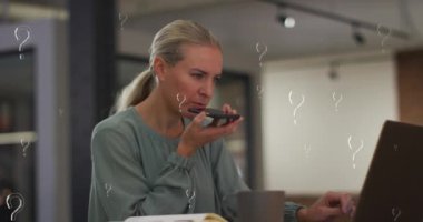 Animation of question marks over caucasian businesswoman working at office. Global business, finances and digital interface concept digitally generated video.