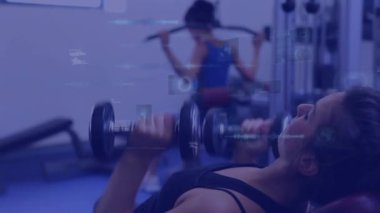 Animation of data processing over woman lifting weights, exercising in gym. Global sports, fitness, computing and data processing concept digitally generated video.