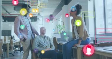 Animation of media icons over diverse business people in office. Global business and digital interface concept digitally generated video.