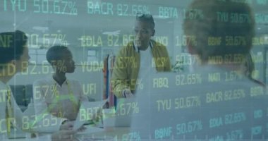 Animation of trading board and graph over diverse coworkers discussing report on laptop in office. Digital composite, multiple exposure, stock market, business, teamwork and technology concept.