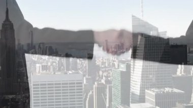 Animation of cityscape over business people shaking hands. Global business, finance, computing and data processing concept digitally generated video.