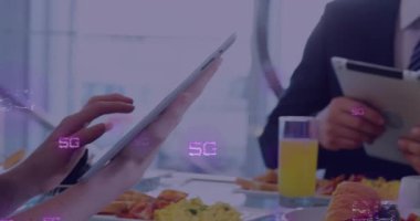 Animation of 5g texts over caucasian business people using smartphone. Global business and digital interface concept digitally generated video.