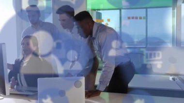 Animation of digital icons over business people using computers. Global business, finance, cloud computing and data processing concept digitally generated video.