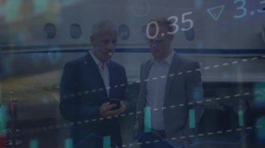 Animation of data processing over caucasian businessmen using smartphone by airplane. Global business travel, finance and data processing concept digitally generated video.