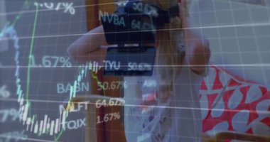 Animation of financial data processing over caucasian woman using vr headset. Global technology, business, finance, computing and data processing concept digitally generated video.
